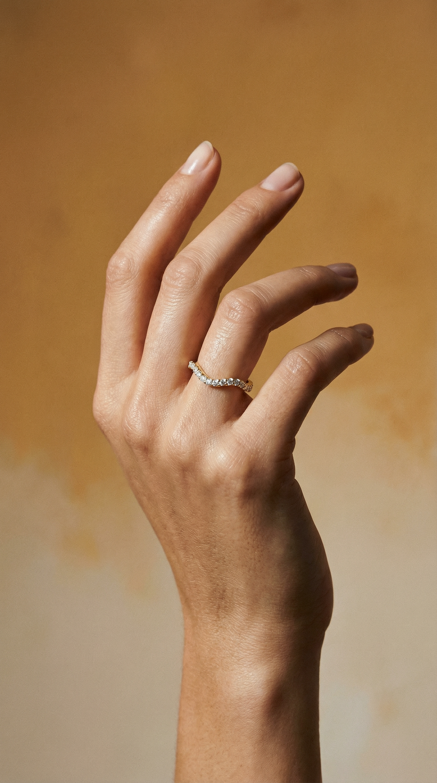 Long Lull Band in 14KY Fairmined Gold with diamonds, modeled on a hand